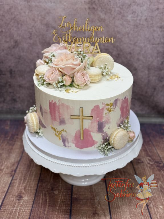 Erstommunionstorte - Goldener Schimmer verziert seitlich die Torte neben den Farbakzenten in rosa und lila.