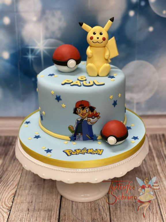 Geburtstagstorte Buben - Ash und Pikatchu sind gemeinsam auf der Torte mit zwei ihrer Pokebälle und vielen kleinen Sternen.