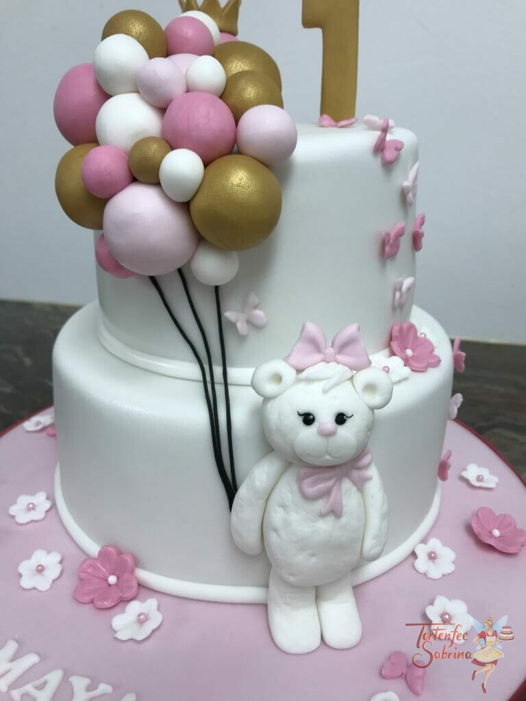 Geburtstagstorte Mädchen - Bär mit vielen Luftballons in den Farben gold, rosa und weiß. Umgeben von Blumen und Schmetterlingen.