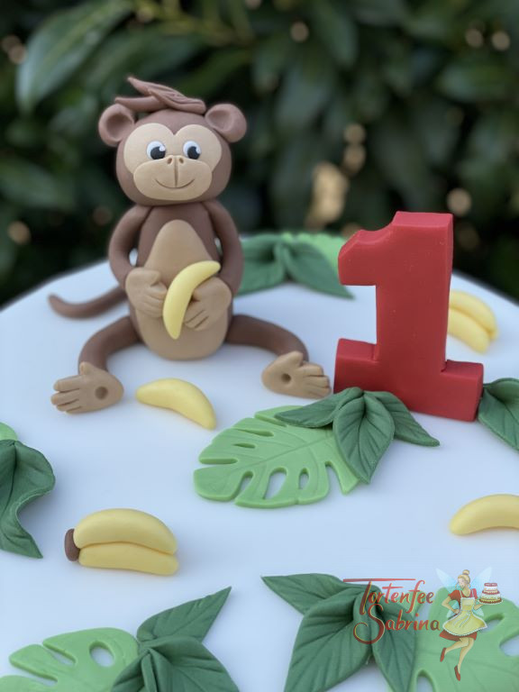 Geburtstagstorte Buben - Bananen für das Äffchen dürfen nicht fehlen, mit auf der Torte sind ein Löwe und eine Giraffe.