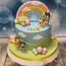 Geburtstagstorte Buben - Bluey und Bingo stehen ganz oben auf der Torte und bewundern den bunten Regenbogen.