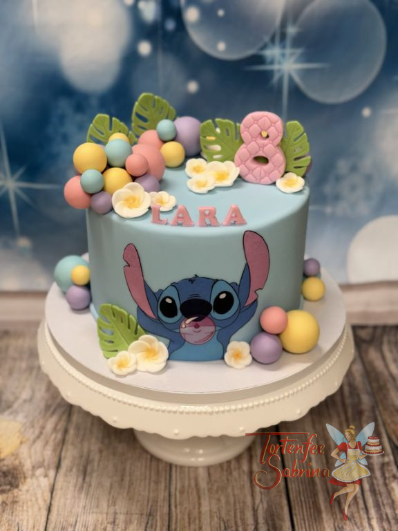 Geburtstagstorte Mädchen - Bunte Blasen von Stitch sind auf der ganzen Torte in verschiedenen Farben verteilt und Stitch vorne drauf.