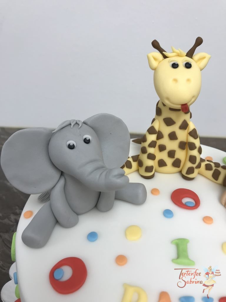 Geburtstagstorte Buben - Bunte Tierwelt, hier sind ein Elefant, eine Giraffe und ein Löwe sitzend auf der Torte und mit bunten Kugeln und Kreisen verziert.