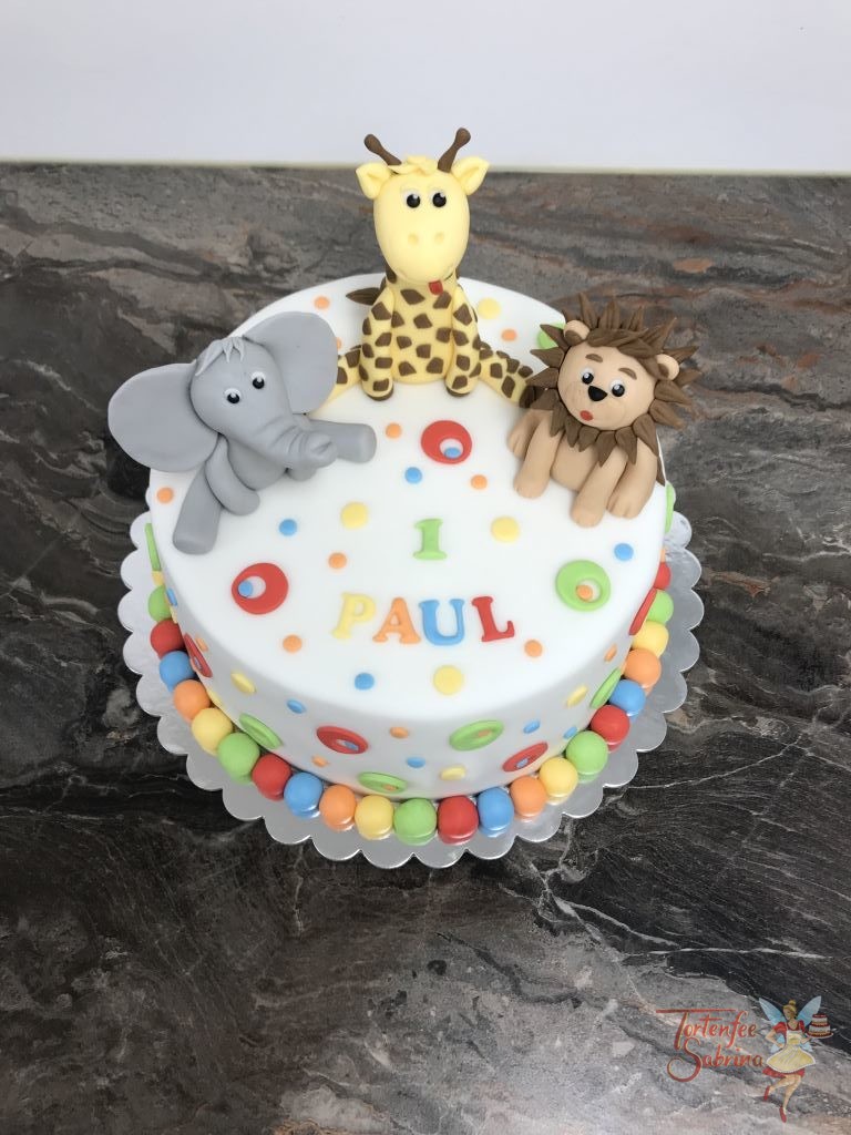Geburtstagstorte Buben - Bunte Tierwelt, hier sind ein Elefant, eine Giraffe und ein Löwe sitzend auf der Torte und mit bunten Kugeln und Kreisen verziert.