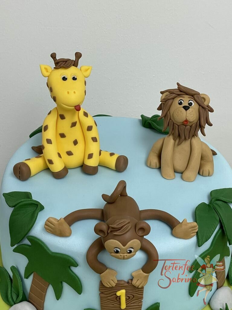 Geburtstagstorte Buben - Der Affe mit der Holztafel hängt wischen den Palmen, die Tafel trägt die Nummer 1 in gelber Farbe.