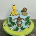 Geburtstagstorte Buben - Der Affe mit der Holztafel hängt wischen den Palmen, die Tafel trägt die Nummer 1 in gelber Farbe.