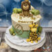 Geburtstagstorte Buben - Der stolze Löwe mit der goldenen Krone oben auf der Torte und sieht seine Freundin die Giraffe.