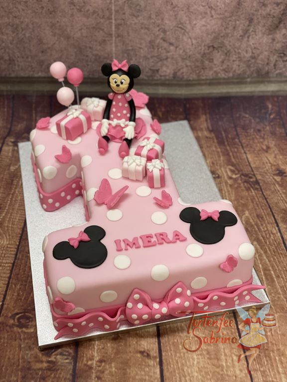 Geburtstagstorte - Die gepunktete Eins in rosa Farbe zieren eine fröhliche Minnie Mouse sowie ein paar Geschenkspäckchen.