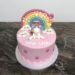 Geburtstagstorte Mädchen - Einhorn mit Regenbogen und Wolken. Torte ganz in Rosa eingedeckt und mit Blumen und Sternen verziert.