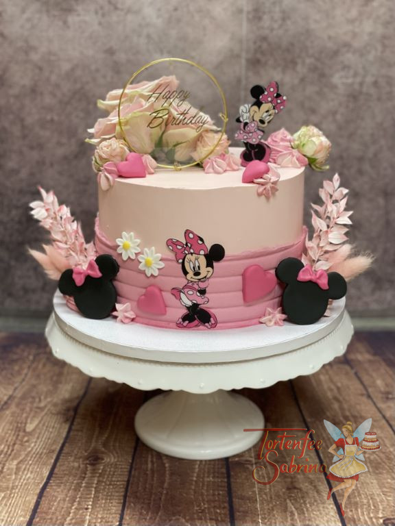 Geburtstagstorte Mädchen - Entzückende Minnie Mouse mit vielen Blumen und Caketopper verziert diese rosa Torte.