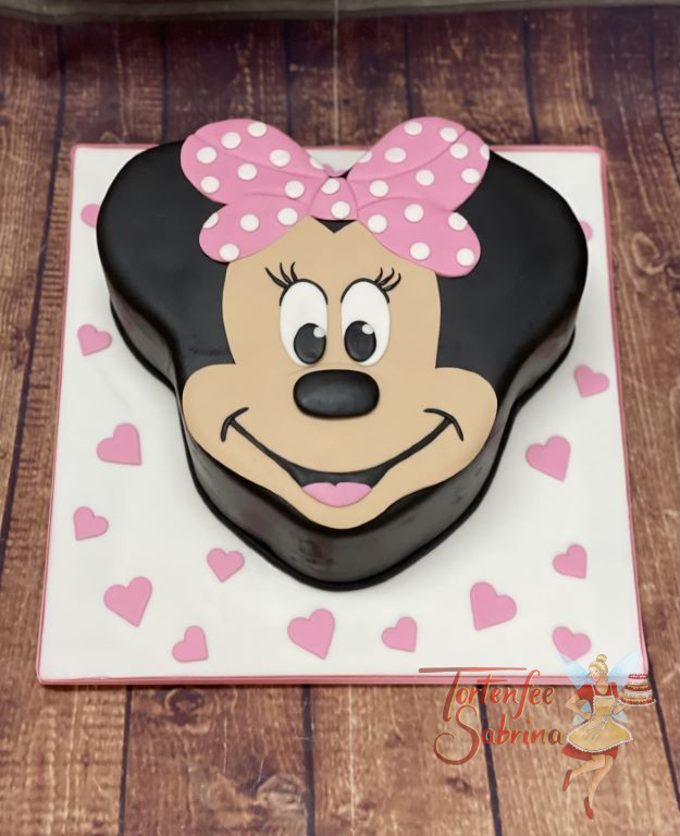 Geburtstagtorte Erwachsene - Entzückende Minnie Mouse lächelt uns in Tortenform entgegen mit ihrer rosa Schleife am Kopf.