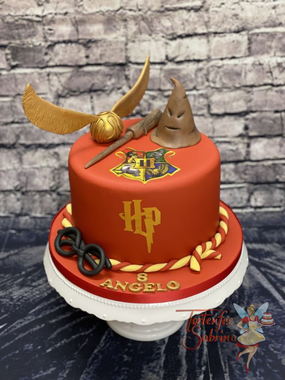 Geburtstagstorte Buben - Hogwarts Wappen in der Mitte auf der Torte über Harrys Initialien. Mitdabei ist der goldene Schnatz.
