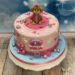 Geburtstagstorte Mädchen - Kleine süße Skye ist ganz oben auf der Torte und ist umgeben von Herzen und Pfotenabdrücken.