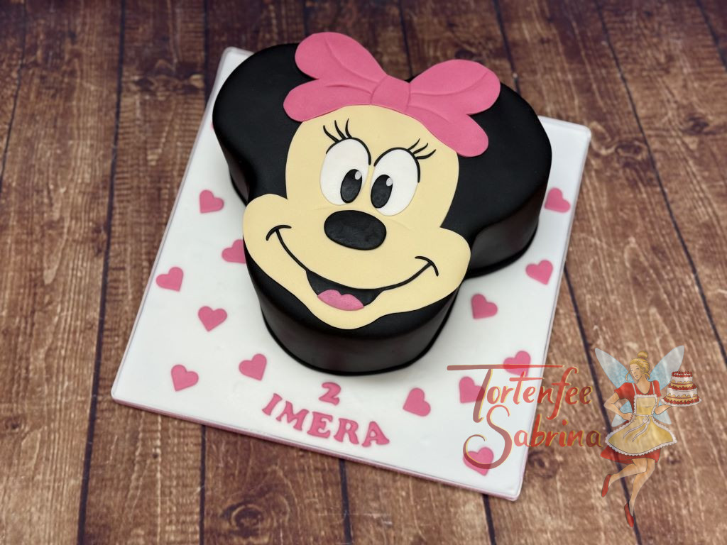 Geburtstagstorte Mädchen - Lächelnde Minnie Mouse wurde hier als Torte nachbacken und natürlich darf die rosa Schleife nicht fehlen.