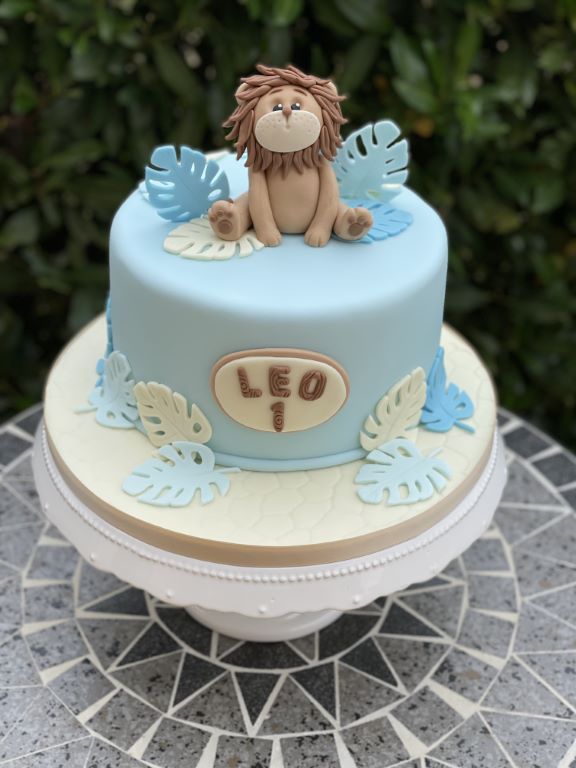 Geburtstagstorte Buben - Leo der Löwe hat es ich auf der Torte gemütlich gemacht und bewundert die blauen Palmenblätter.