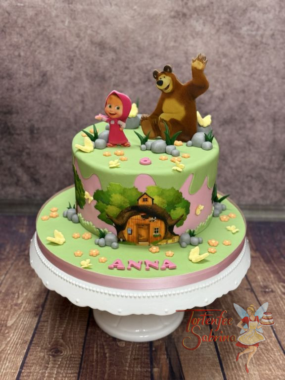 Geburtstagstorte Mädchen - Mascha´s Häuschen ist ganz vorne auf der Torte zu sehen und oben auf der Torte winkt der Bär.