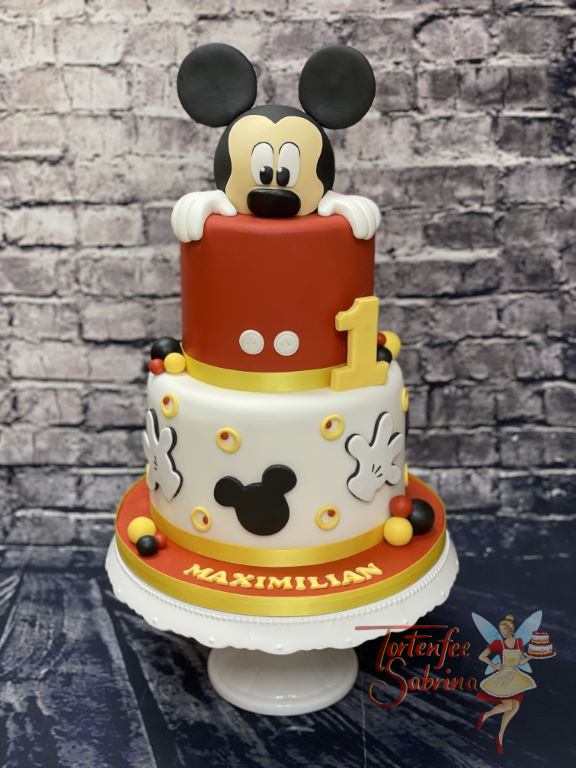 Geburtstagstorte Buben - Mickey schaut heraus und zwar ganz oben aus der zweistöckigen rot und weißen Torte.