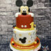 Geburtstagstorte Buben - Mickey schaut heraus und zwar ganz oben aus der zweistöckigen rot und weißen Torte.