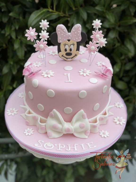 Geburtstagstorte Mädchen - Minnie ganz in rosa mit einer Schleife am Kopf und als Abschluss bei der Torte ist ebenfalls eine Schleife.
