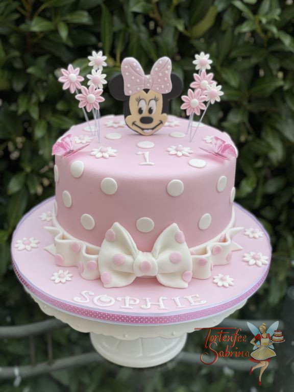 Geburtstagstorte Mädchen - Minnie ganz in rosa mit einer Schleife am Kopf und als Abschluss bei der Torte ist ebenfalls eine Schleife.