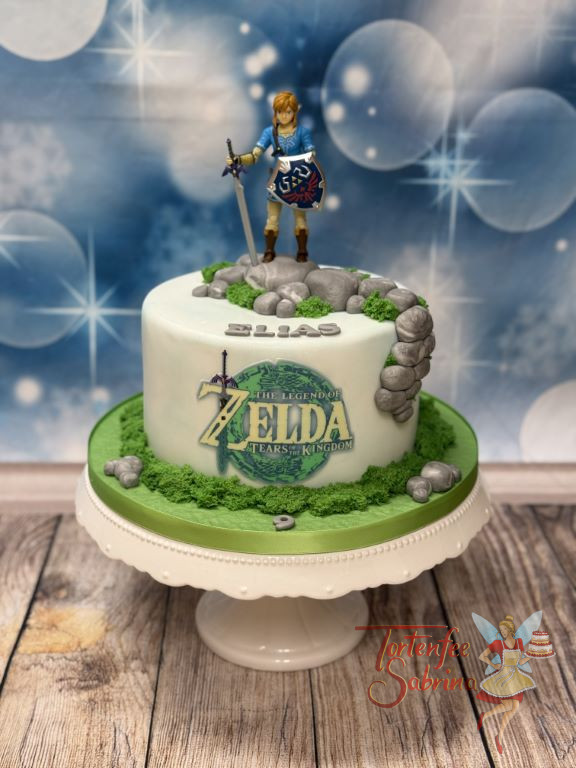 Geburtstagstorte - Mutiger Link von der Legende von Zelda, steht oben auf der Torte mit seinem Schwert und Schild.