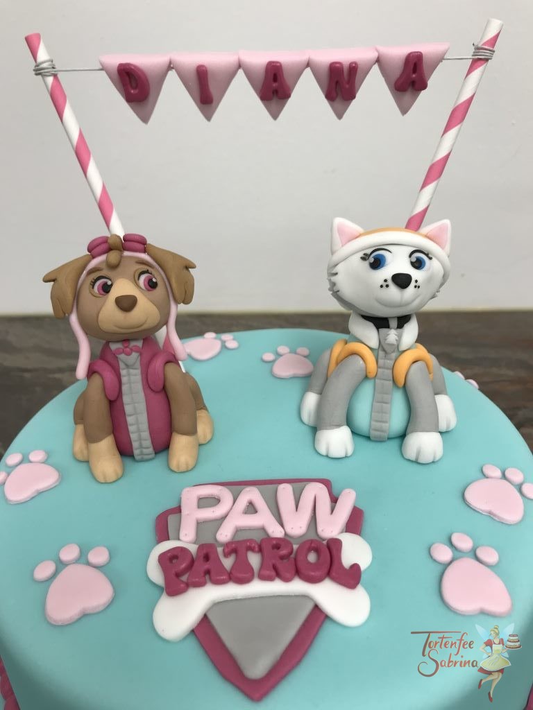 Geburtstagstagstorte Mädchen - Party mit Everest und Skye, dekoriert mit dem Paw Patrol Logo, Pfotenabdrücken und einer Namensgirlande.