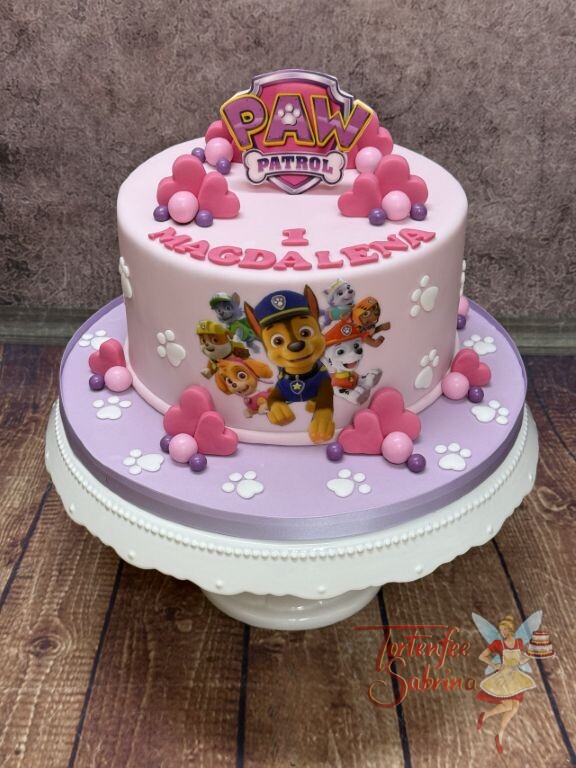 Geburtstagstorte Mädchen - Paw Patrol unterwegs dieses Mal in der Farbe rosa, verziert wurde die Torte mit Kugeln und Herzen.