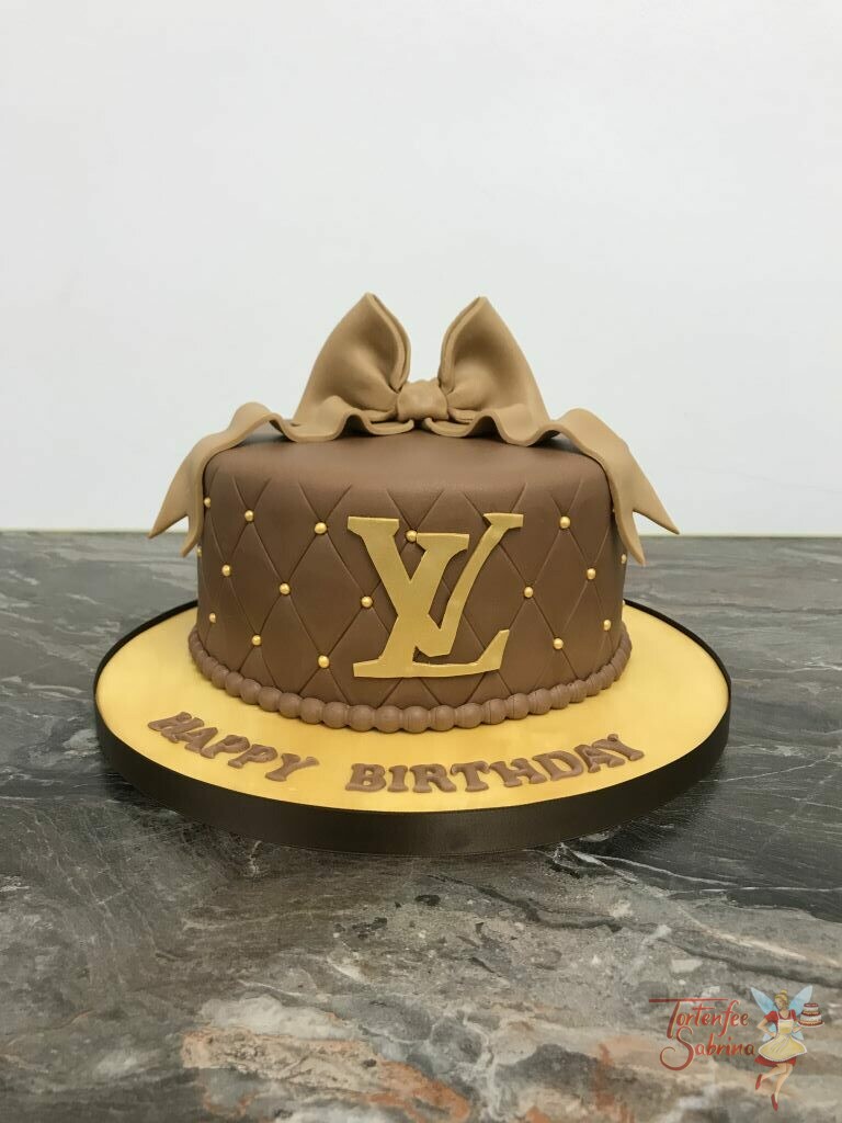 Geburtstagstorte Erwachsene - Runde Tasche hier ist das Logo in Gold gehalten und die Torte wurde oben mit einer braunen Schleife verziert.