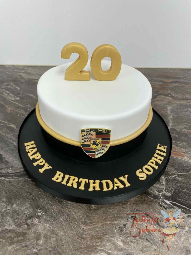 Geburtstagstorte Erwachsene - Schwarz-Weiß-Porsche zeigt eine zweifärbige Torte mit goldenem Band und dem Porsche-Emblem.