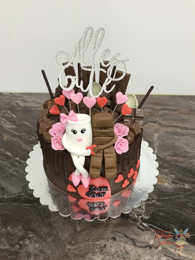 Geburtstagstorte Erwachsene - Süßer Schokoriegel mit Milchglass und vielen verschiedenen Süßigkeiten. Ebenso wurde die Torte mit Herzen und Blumen verziert.