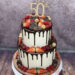 Geburtstagstorte Erwachsene - Viele Schokoherzen und rote Beeren verzieren den zweistöckigen Drip Cake mit Caketopper.