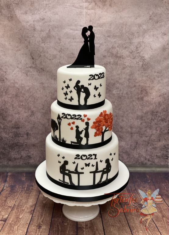Hochzeitstorte - Die Geschichte der Liebe wird hier in vier Szenen auf der Torte erzählt und gekrönt von einem Caketopper.
