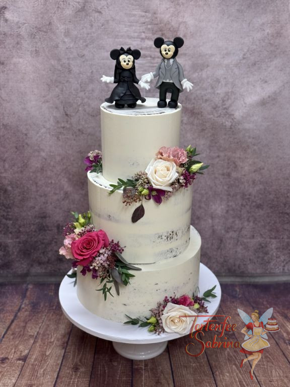 Hochzeitstorte - Minnie und Mickey geben sich in der Kleidung des Brautpaars das Ja-Wort, umgeben von wundervollen Blumen.