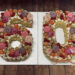 Number Cake - 60er mit Rosen, Macarons und Früchten in zarten rosa Tönen ist als Geschenk für den Jubilar gedacht.