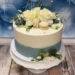 Tauftorte - Kleine Blüten des Lisianthus verzieren neben den großen Blüten der Rosen die blau-weiss eingestrichene Torte.