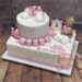 Tauftorte - Kleine rosa Uhr zeigt die Geburtszeit, ebenso ist auf der Torte das Datum, Gewicht und Größe des Täuflings zu sehen.
