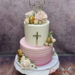 Tauftorte - Rosa Rillen verschönern den unteren Stock der Torte, oben ist der goldene personalisierte Caketopper der Blickfang.